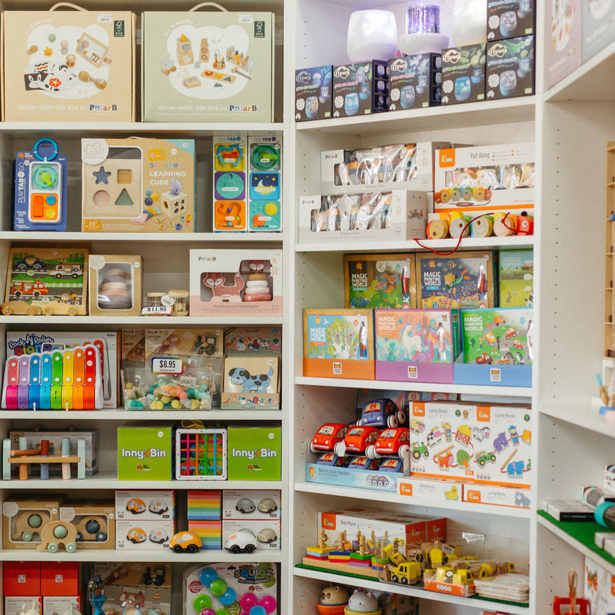 Shelves filled with various toys and products in a store setting
