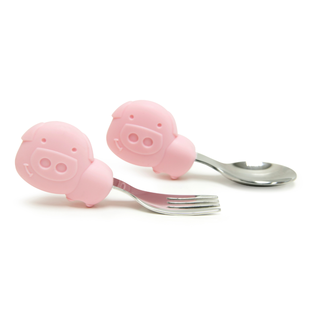 Marcus & Marcus Pig Palm Grasp Spoon and Fork Set in pink, BPA-free silicone and stainless steel toddler cutlery for ages 18m+